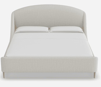 A light-colored upholstered bed frame with a curved headboard and integrated side rails. The bed has a low profile and stands on four slender, tapered wooden legs. It is shown with white bedding, including two pillows. — 3D model
