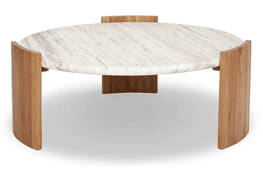 A contemporary round coffee table featuring a substantial marble top with prominent veining and a unique, curved wooden base. The tabletop appears to be made of natural stone, possibly travertine or marble, exhibiting a creamy white base with grey and beige striations. The base is constructed from solid wood, with four curved, quarter-circle-like panels that support the circular top and create an open, airy aesthetic. The wood grain is clearly visible, suggesting a natural finish. The overall design is sculptural and modern, blending natural materials for a sophisticated yet grounded appearance. — 3D model