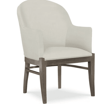 A cream-colored armchair with a high, curved back and upholstered arms. The seat is also upholstered in the same fabric. The frame and legs are made of wood with a weathered, gray-brown finish. The legs have a slightly tapered profile. — 3D model