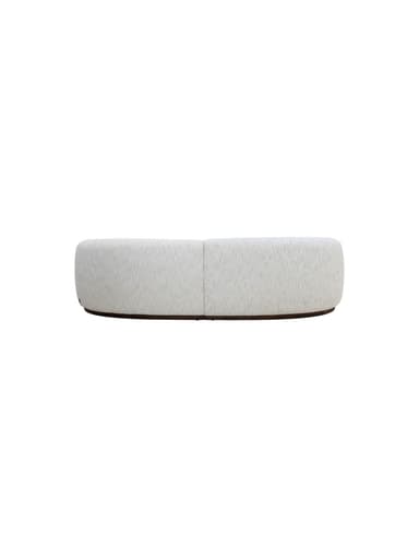 A curved sofa with a rounded armrest on the left side. The sofa features a plush, textured upholstery and a dark, possibly wood, base that follows the organic curve of the seating. — 3D model