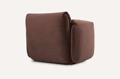 A contemporary armchair with plush upholstery and generous cushioning. The armchair features rounded edges and deep, inviting seat and backrest areas, complemented by loose back cushions that add to its comfortable and relaxed aesthetic. It is presented against a neutral background. — 3D model