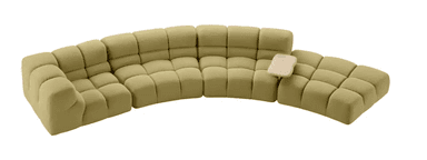 A modular, sectional sofa with a curved configuration. Each module consists of multiple tufted cushions, creating a soft, pillowed appearance. The sofa is upholstered in a textured fabric and features a light-colored, organically shaped tray attachment on one of the sections. — 3D model