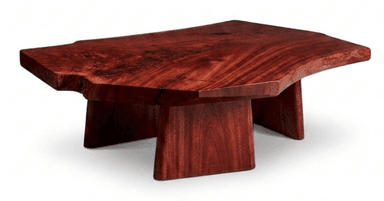 A low-profile coffee table crafted from a single slab of rich reddish-brown solid wood, featuring a live edge tabletop that retains the natural organic shape of the tree. The table is supported by two thick, geometric block-like legs that provide a sturdy and minimalist base, complementing the natural aesthetic of the top. — 3D model