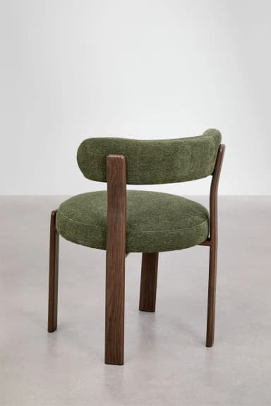 A contemporary chair featuring a dark wood frame and green upholstered seat and back. The backrest is curved and supported by two prominent wooden uprights from the rear legs. — 3D model