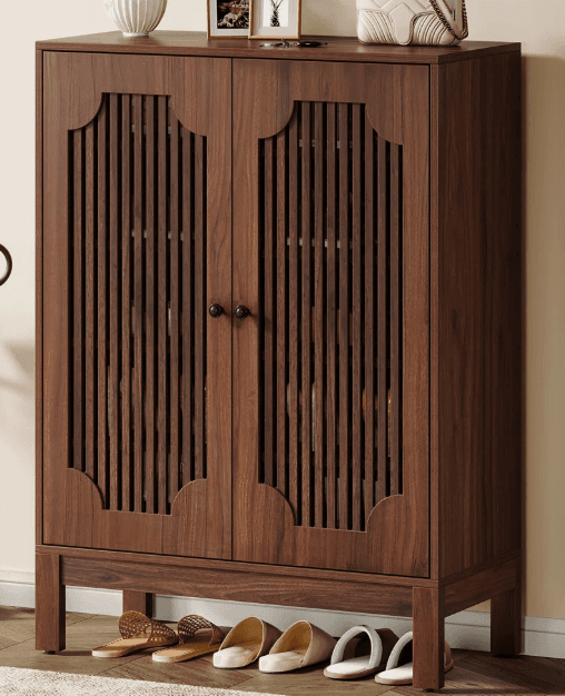 A two-door cabinet with vertical slat detailing on the doors and a decorative scalloped top edge. It stands on four straight legs and has two small, dark knobs as handles. — 3D model