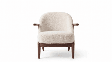 A contemporary lounge chair featuring a sturdy dark wood frame and plush, off-white boucle upholstery. The design incorporates a rounded backrest and integrated armrests, providing a comfortable and enveloping seating experience. The wooden frame includes elegantly tapered legs, contributing to its modern aesthetic. The chair is presented against a clean white background, highlighting its form and texture. — 3D model