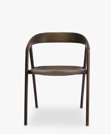 A contemporary armless chair crafted from dark walnut wood, featuring a curved backrest and a subtly sculpted seat, supported by four slender, round legs. — 3D model