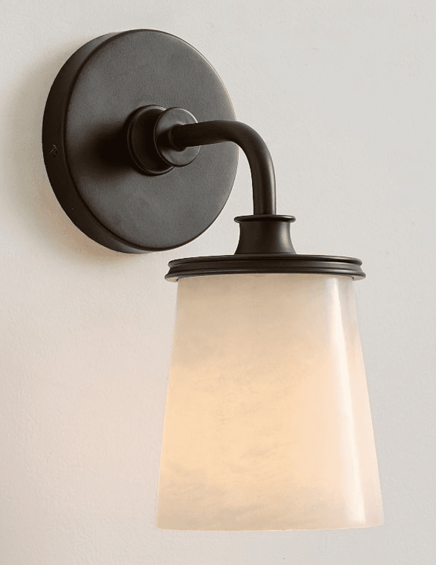 A wall-mounted lighting fixture featuring a dark bronze finish and a translucent, tapered alabaster glass shade, designed to provide ambient illumination. — 3D model