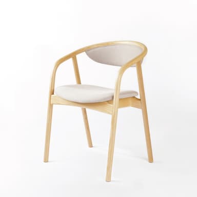 A modern armchair constructed with a light-toned wooden frame and upholstered seat and backrest. The frame features smoothly curved armrests and back support. The design is minimalist and contemporary, with slender, tapered legs. — 3D model