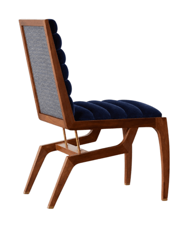 A low-profile accent chair with a wooden frame and a deep blue upholstered seat and backrest. The upholstery features horizontal channel tufting on both the seat and back. The chair has a distinctive angular wooden base with four tapered legs, the front two having a curved profile and the rear legs forming a more geometric structure. Small brass ferrules are visible on the feet of the front legs. — 3D model