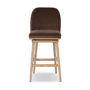 A bar stool with a wooden base and a upholstered seat and backrest. The stool has a swivel mechanism. The wooden legs are angled outwards, and there are crossbars for stability. The seat and backrest are covered in a textured fabric, likely velvet, in a brown hue. — 3D model