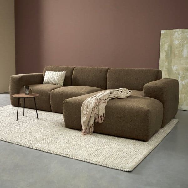 A contemporary modular sectional sofa featuring a chaise lounge, upholstered in a textured brown fabric. The design emphasizes rounded edges and a low profile, offering a comfortable and adaptable seating solution. — 3D model
