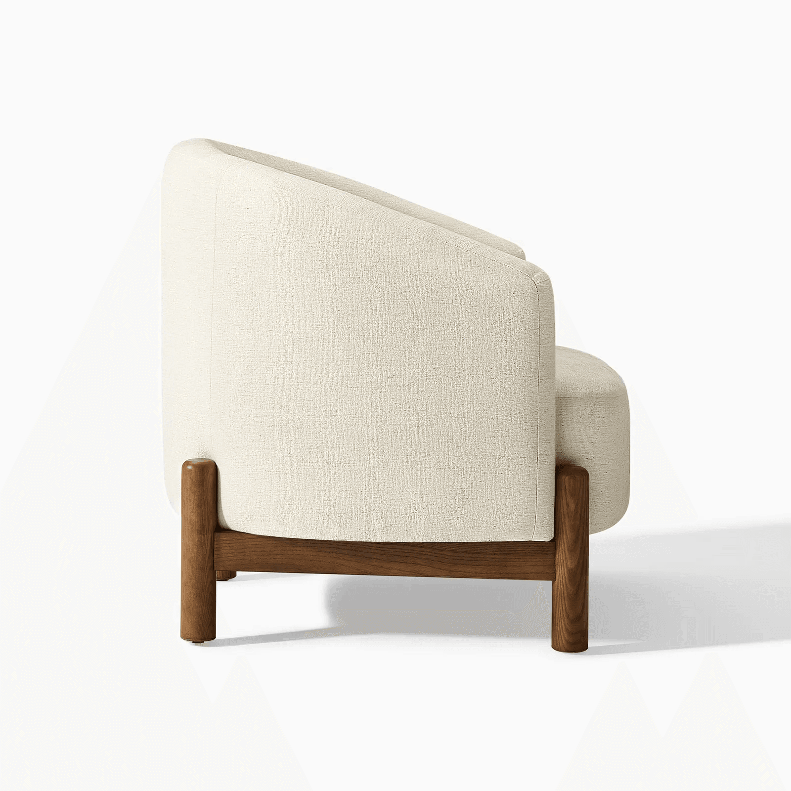 A modern armchair upholstered in a textured, light-colored fabric. It features a gently curved backrest that extends to armrests. The chair is supported by a dark wood frame with distinct legs that are cylindrical at the bottom and square where they meet the seat. — 3D model