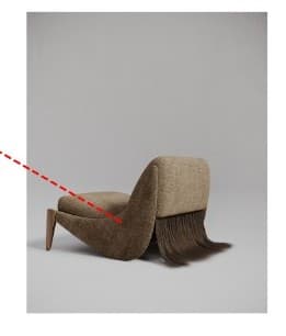 An armchair with an upholstered seat and backrest, featuring a unique design element resembling fringe or hair cascading from the back. The armchair has a wooden leg support on one side and a curved, organic shape to the seat and back. The upholstery has a textured weave. — 3D model