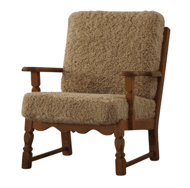 A wooden armchair with a high back and wide seat, upholstered with a thick, textured natural-colored sheepskin or similar fuzzy material. The frame has visible wooden legs and armrests. The wood appears to be a medium-toned oak or similar hardwood. — 3D model