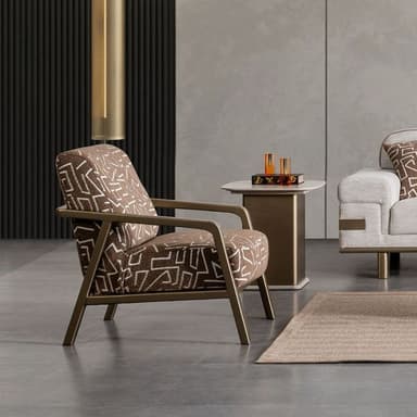 A contemporary lounge chair featuring a bronze-toned metal frame and upholstered cushions with a distinctive brown and white geometric pattern. — 3D model