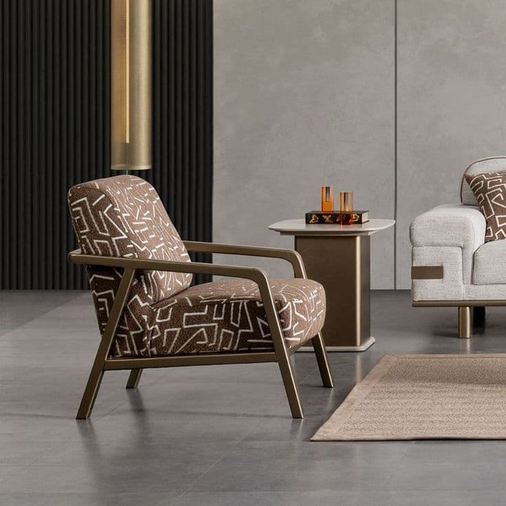 A contemporary lounge chair featuring a bronze-toned metal frame and upholstered cushions with a distinctive brown and white geometric pattern. — 3D model