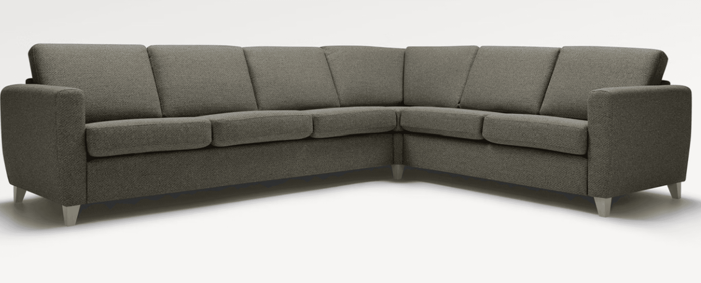 A sectional sofa with a low-profile design and clean lines. It features multiple seat cushions and back cushions, upholstered in a textured, woven fabric. The sofa is supported by short, tapered wooden legs. — 3D model