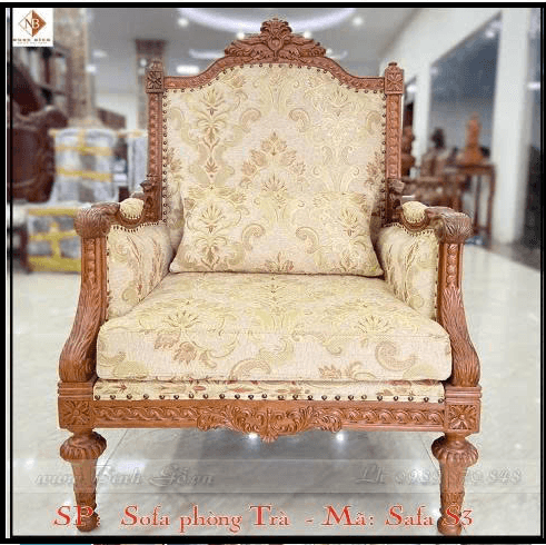 An ornate traditional armchair featuring a prominent carved wooden frame and rich floral upholstery. The chair has a high, slightly curved back with intricate carving at the crest. The armrests are also carved, flowing into the front legs which are turned and fluted, ending in small bun feet. The seat and backrest are generously upholstered in a patterned fabric, and a matching lumbar pillow is included. Decorative nailhead trim borders the upholstery panels. — 3D model