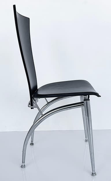 A modern chair featuring a black, curved backrest and a black, cushioned seat. The frame and four tapered legs are constructed from brushed metal, offering a sleek, contemporary aesthetic. The seat appears to be upholstered, possibly in leather or a similar synthetic material, and is supported by a silver-toned metal frame that extends to the legs. — 3D model