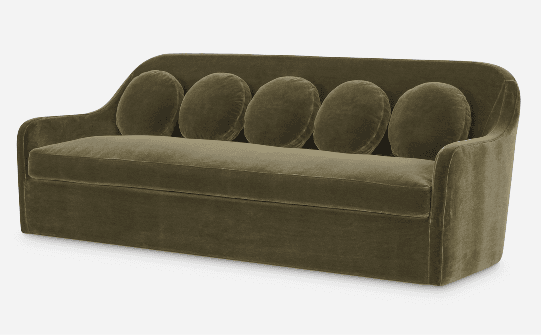 A modern olive green velvet sofa with a sleek, low-profile design and rounded arms. It features a continuous back and includes five matching round bolster pillows for added comfort and style. The sofa is upholstered in soft velvet fabric and has a skirted base, concealing any legs. — 3D model