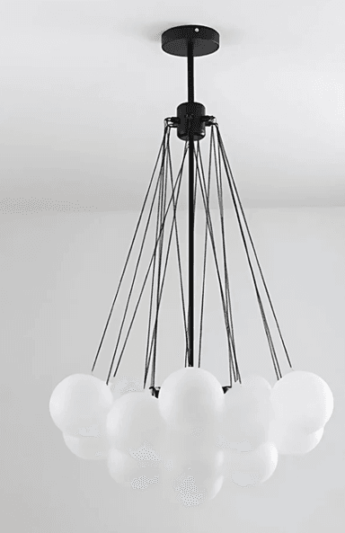 A modern chandelier featuring a black metal frame with multiple thin suspension wires supporting a circular frame. Attached to the circular frame are numerous spherical white glass shades, arranged in a cluster. The chandelier suspends from a central black rod connected to a ceiling mount. — 3D model