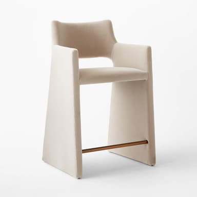 A contemporary bar stool with a sleek, minimalist design. It features a high back and armrests that are integrated into the main frame. The seat is upholstered, and the legs are substantial and straight. A metallic footrest spans between the two front legs, providing additional stability and functionality. — 3D model