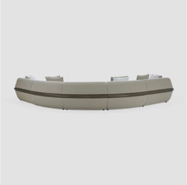 A large, modular, curved sectional sofa upholstered in a textured, light-colored fabric with a subtle speckled pattern. The sofa features several individual seating modules forming a gentle arc. It is accompanied by throw pillows in complementary neutral tones. Distinctive design elements include curved armrests and side panels with inset wood-look trim, adding a contemporary and sophisticated aesthetic. — 3D model