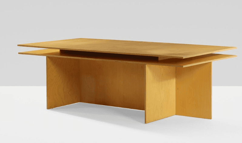 A modern executive desk featuring a distinct layered plywood construction, presenting a light wood finish and a minimalist aesthetic. — 3D model