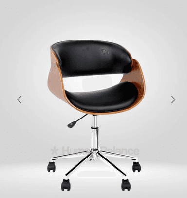 A bentwood swivel desk chair featuring a curved plywood shell with a walnut veneer, complemented by black faux leather upholstery on the seat and backrest. It rests on a five-star chrome-plated metal base equipped with black casters and an adjustable height mechanism. — 3D model