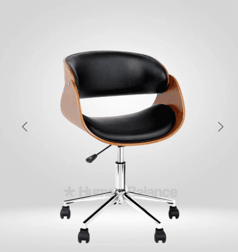 A bentwood swivel desk chair featuring a curved plywood shell with a walnut veneer, complemented by black faux leather upholstery on the seat and backrest. It rests on a five-star chrome-plated metal base equipped with black casters and an adjustable height mechanism. — 3D model