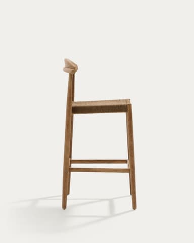 A light-toned solid wood bar stool with a woven rope seat and a curved, low backrest. It features a sturdy four-legged frame with a metal footrest bar for comfort and support. The design is minimalist and draws from natural materials. — 3D model