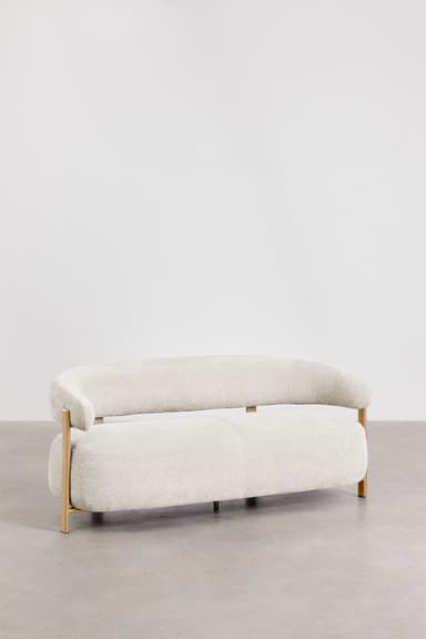 A contemporary sofa with a curved, organic shape. It features a thick, upholstered seat and backrest with rounded edges. The frame is partially exposed, with light-colored wooden legs and armrest supports that extend upward. The upholstery appears to be a textured fabric. — 3D model