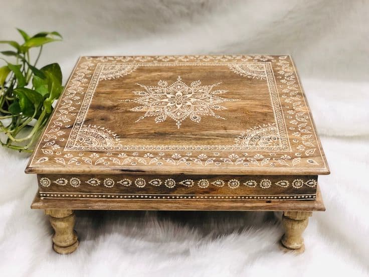 A low, square wooden accent table featuring intricate white mandala and border patterns on its top surface. It is supported by four turned, short legs. — 3D model