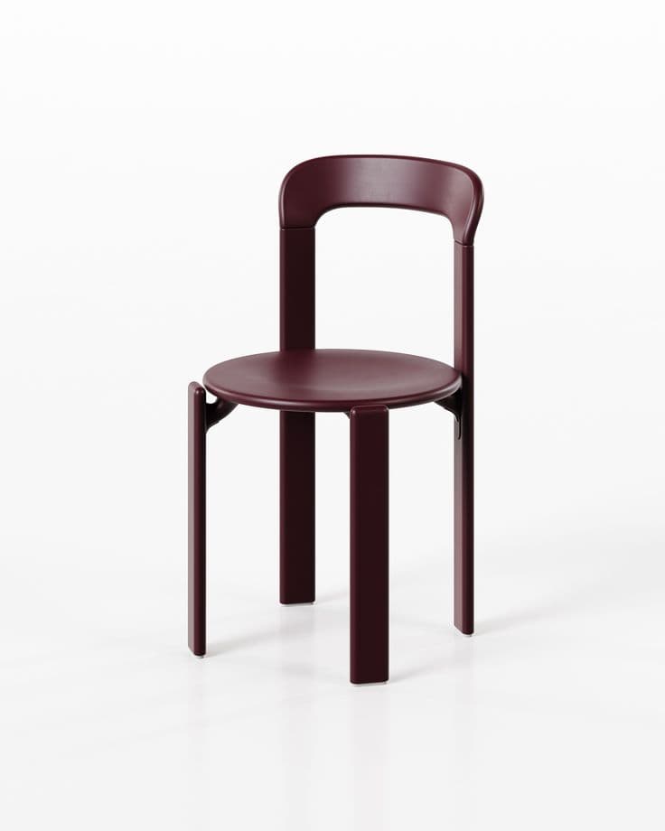A contemporary armless dining chair crafted from what appears to be a single piece of molded plastic or composite material, featuring a matte burgundy finish. The chair exhibits a minimalist design with a gently curved backrest that integrates seamlessly into the rear legs, and a circular seat supported by sturdy, wide legs. — 3D model