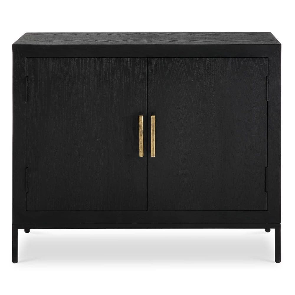A sleek, rectangular storage cabinet with two doors, finished in black-stained wood with a visible grain texture. It features two prominent vertical brass bar handles and stands on a minimalist black metal frame base. — 3D model