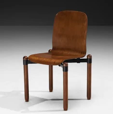 A contemporary chair with a contoured wooden seat and backrest, supported by cylindrical wooden legs and a black metal frame. The design features a minimalist aesthetic with rounded edges. — 3D model