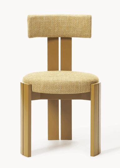 A modern dining chair with a distinct geometric design. The chair features a padded seat and a T-shaped backrest, both upholstered in a textured yellow fabric. The frame and legs are constructed from a solid material, possibly wood or metal, finished in a matte gold or brass color. The legs have a unique angular profile, with two parallel vertical elements forming each front leg. — 3D model
