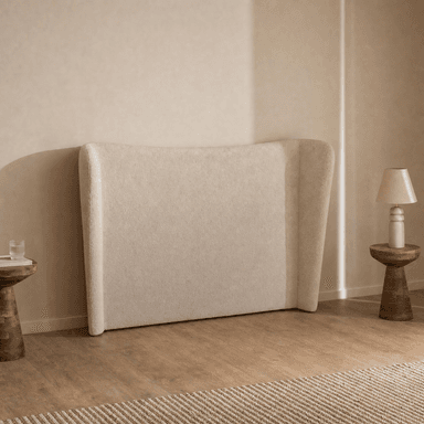 A modern upholstered headboard featuring a wingback design, covered in a textured, light beige fabric. — 3D model