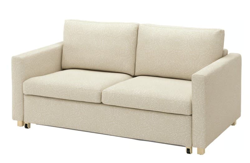 A contemporary two-seater sofa, commonly known as a loveseat, upholstered in a light beige or cream fabric with a subtle, organic, light-toned patterned design. It features clean, straight lines with block-style track arms, two separate loose seat cushions, and two loose back cushions, all matching the same patterned upholstery. The base of the sofa is skirted, concealing the frame, but small, golden-finished block feet are visible at the bottom corners. — 3D model