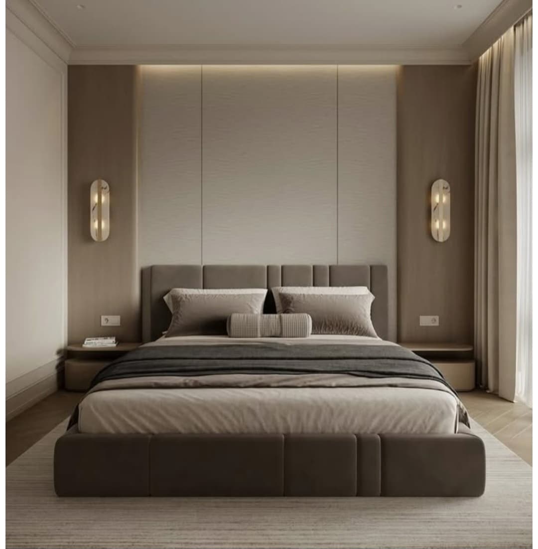 A low-profile upholstered bed frame with a rectangular headboard and bedding. The frame is dark brown and appears to be padded. The bedding consists of a fitted sheet, a duvet or comforter, a throw blanket, and several pillows, including two standard pillows and a cylindrical bolster pillow. The overall presentation suggests a modern and minimalist aesthetic. — 3D model
