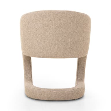 A contemporary accent chair with a curved backrest and upholstered seat and frame. The chair features a rounded, open base structure that flows into the armrests and back. — 3D model