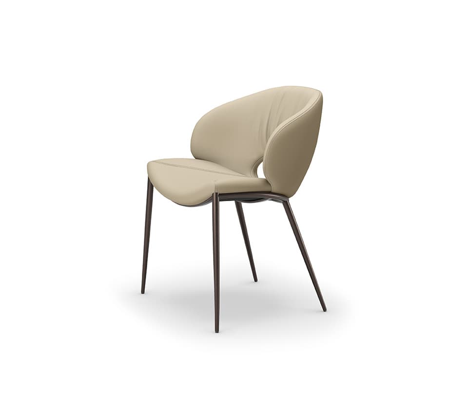 A contemporary dining chair featuring a gracefully curved, upholstered seat and backrest in a light beige or cream color. The design incorporates integrated armrests that flow seamlessly from the back. The chair is supported by four slender, tapered metal legs in a dark, possibly bronze or black finish, providing a minimalist and elegant profile. A distinctive cut-out detail is present on the lower backrest. — 3D model