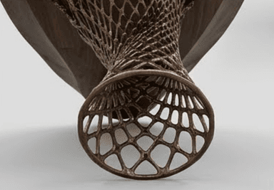 A striking console table featuring a dark wood tabletop with a wavy, perforated apron, supported by two intricate, sculptural bases made from a bronze-toned metal. — 3D model