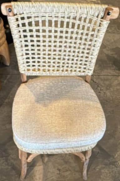 A dining chair with a woven rope backrest and a cushioned seat. The frame and legs are made of wood with a natural finish. The backrest features a diamond-shaped woven pattern. — 3D model