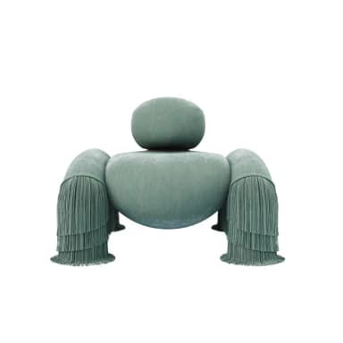 A highly stylized and sculptural lounge chair upholstered in a soft, plush greenish-blue velvet-like fabric, featuring prominent, multi-layered fringe tassels on its four rounded, stubby supports. It includes a separate, rounded backrest cushion that maintains the overall organic form. — 3D model
