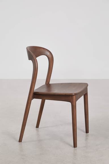 A contemporary dining chair crafted from dark wood, featuring a gracefully curved backrest that seamlessly transitions into the rear legs. The seat is flat and slightly rounded at the edges, supported by four tapered legs. The overall design emphasizes smooth lines and a minimalist aesthetic. — 3D model
