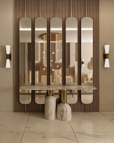An elegant and contemporary console table featuring a luxurious white marble tabletop with grey veining. The table is supported by two substantial, rounded marble bases with brass accents. Integrated into the design is a tall, decorative screen composed of multiple vertical, rounded-edge panels, likely made of frosted glass or acrylic, framed in polished brass. A horizontal brass bar connects the top of these panels, unifying the structure. The overall aesthetic is one of sophisticated modernism with Art Deco influences, designed to serve both as a display surface and a subtle room divider. — 3D model