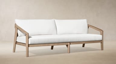 A modern outdoor two-seater sofa featuring a sturdy, light-toned wooden frame and plush white upholstered cushions for both seat and back. — 3D model