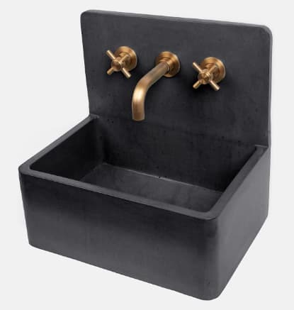 A dark gray, rectangular, wall-mounted concrete sink featuring an integrated backsplash. The sink is paired with a three-piece brass faucet set, including a central curved spout and two cross-handle hot and cold taps mounted directly into the concrete backsplash. — 3D model
